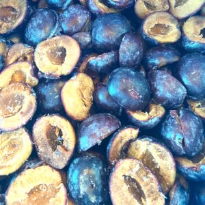 Frozen, halved plums